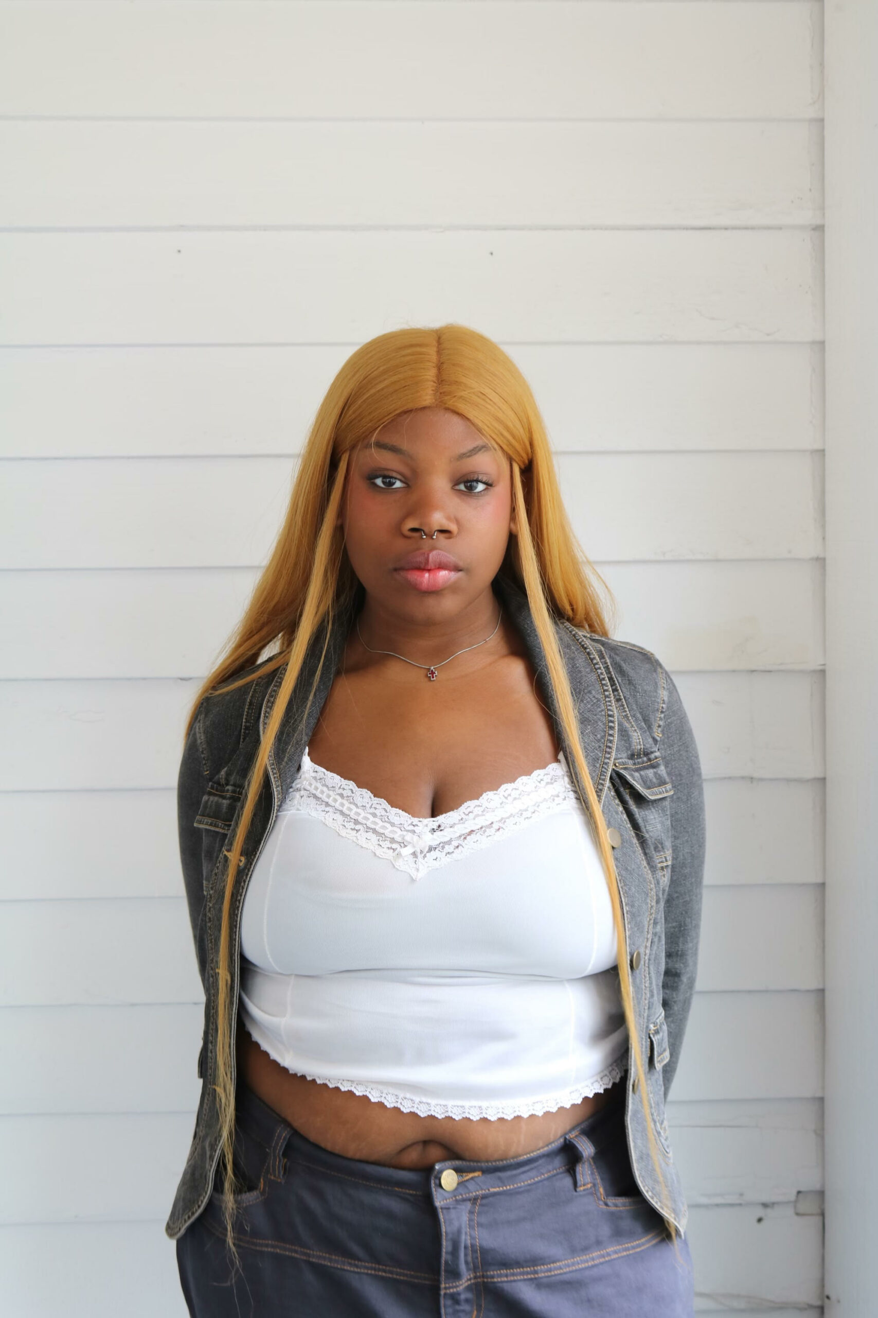 Headshot of Connie Duopu looking straight ahead in a white shirt and jean jacket.