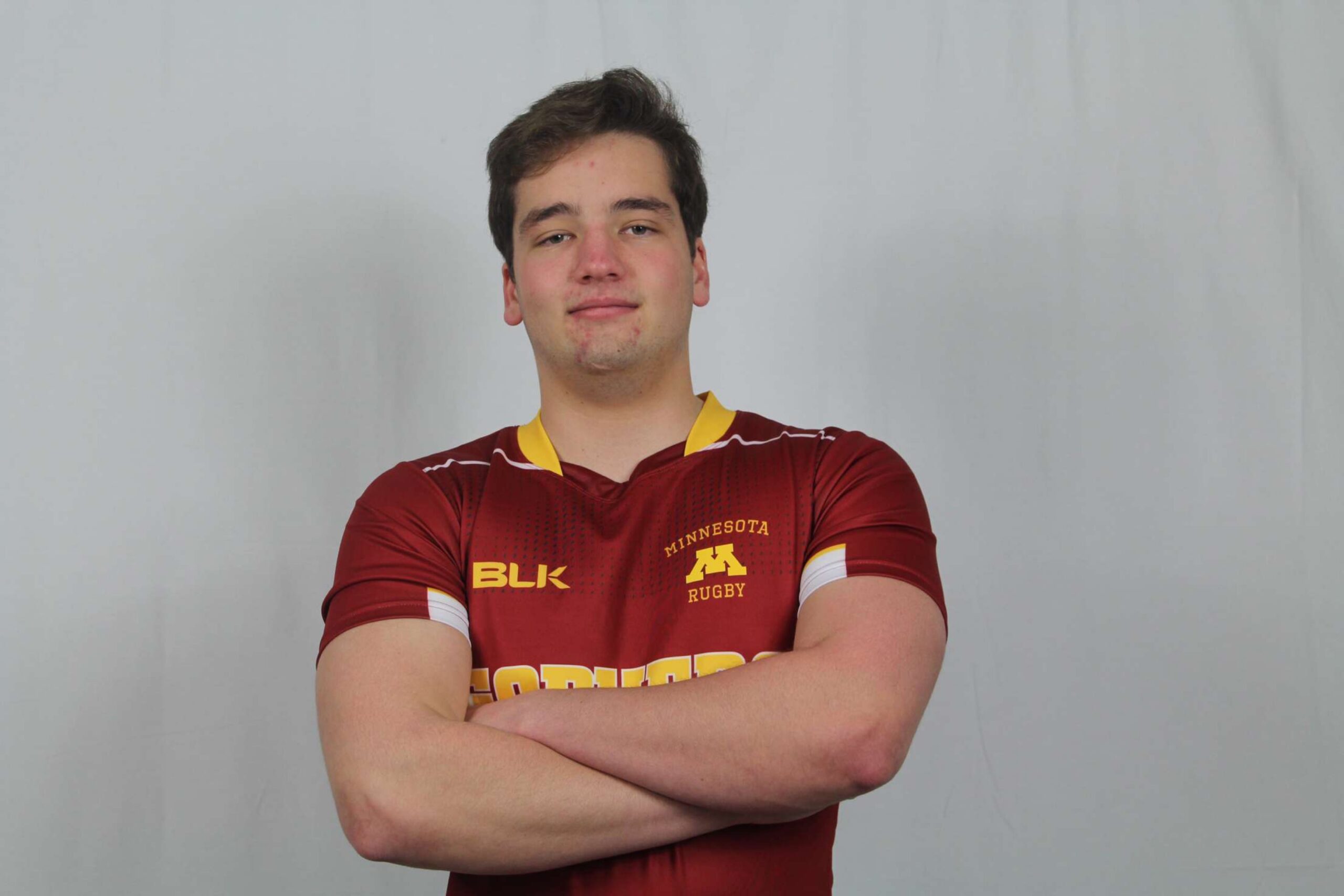 Headshot of Ryan Cardenas, looking straight ahead in a red shirt.